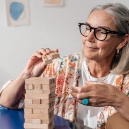 Older woman working on a puzzle.