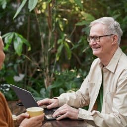 Older couple enjoying lunch at an outdoor cafe.